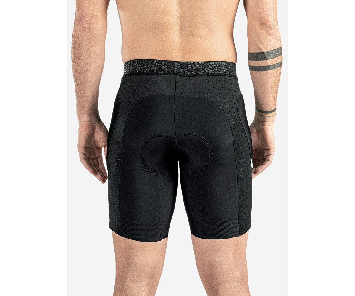 Back view of Bluegrass Aura Shorts worn by a rider, showcasing certified hip protection and breathable, stretch fabric